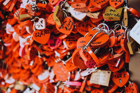 Many red locks in the form of hearts with the names of lovers. Near Juliet's house in Verona. Love,...