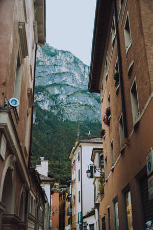 Italy. Trentino 07/09/2022 Riva del Garda. Houses and architecture of the city against the backdrop of mountains. Beauty and vacation, summer day, travel. Cardの写真素材