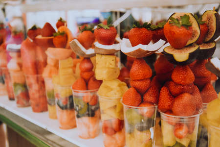 Fruit diet, fruits in a cup, strawberries, coconut and pineapples with kiwi. Italian snack. Healthy lifestyleの写真素材