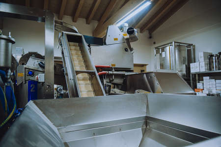 Olive oil plant. Olive farm with a factory. Machines for the production of olive oil and packagingの写真素材