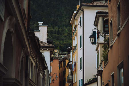 Riva del Garda. Houses and architecture of the city against the backdrop of mountains. Beauty and vacation, summer day, travel. Cardの写真素材