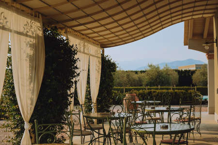 Beautiful Italian-style terrace in a field with olive fields in the background. Comfort and relaxation, boho styleの写真素材
