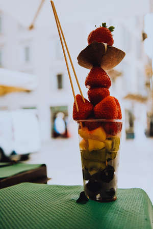 Fruit diet, fruits in a cup, strawberries, coconut and pineapples with kiwi. Italian snack. Healthy lifestyleの写真素材