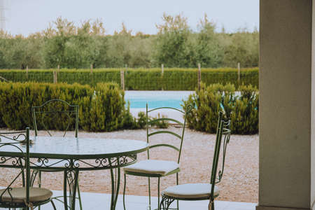 Beautiful Italian-style terrace in a field with olive fields in the background. Comfort and relaxation, boho styleの写真素材