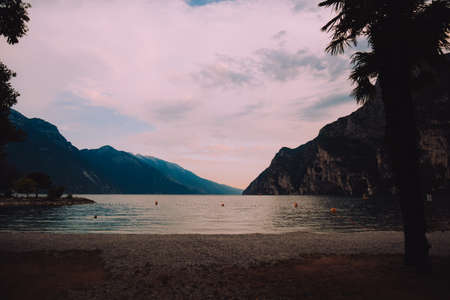 Island and palm trees against the backdrop of sunset, summer and evening beauty rest. Nature and lakeの写真素材