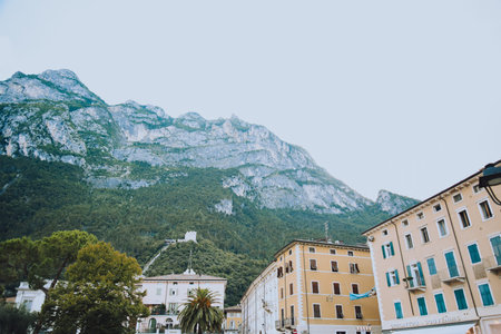 Italy. Trentino 07/09/2022 Riva del Garda. Houses and architecture of the city against the backdrop of mountains. Beauty and vacation, summer day, travel. Cardのeditorial素材