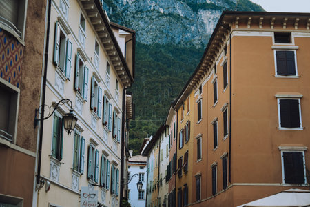 Riva del Garda. Houses and architecture of the city against the backdrop of mountains. Beauty and vacation, summer day, travel. Cardのeditorial素材