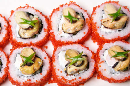 Elite sushi on a white background in red tobiko caviar with mussels on top. Foodの写真素材