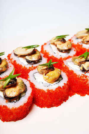 Elite sushi on a white background in red tobiko caviar with mussels on top. Foodの写真素材