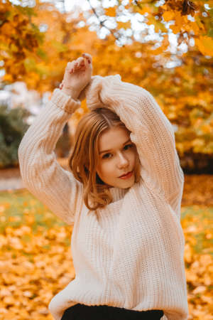 Beautiful photo teen girl in park in autumn.の写真素材