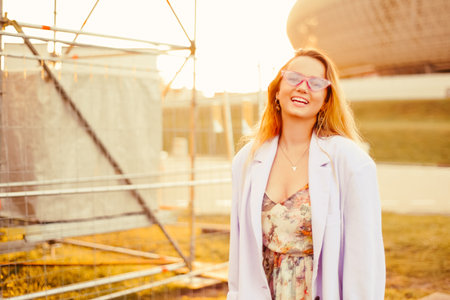 Portrait of a girl at the festival in the sun on the background of the sunset.の写真素材