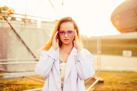 Portrait of a girl at the festival in the sun on the background of the sunset.の写真素材