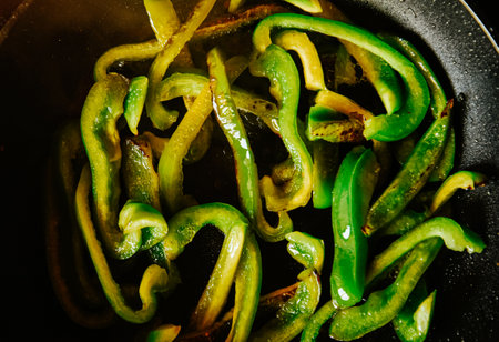 Beautiful green peppers are fried in a frying pan on an olii. Healthy food, fried vegetablesの写真素材