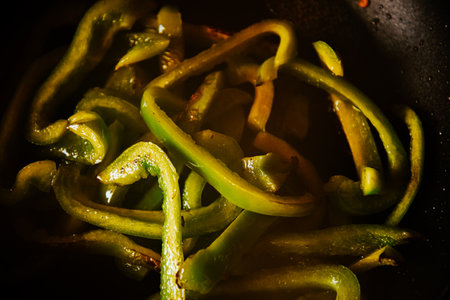 Beautiful green peppers are fried in a frying pan on an olii. Healthy food, fried vegetablesの写真素材