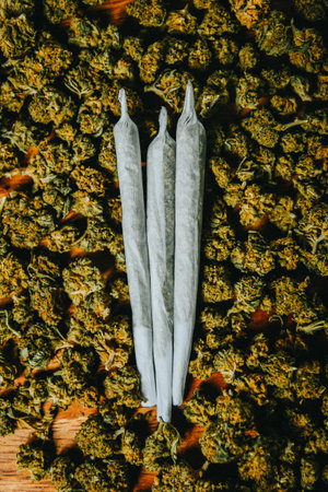 Joints are on the table. Three crossed joints in marijuana buds, indica sativa Ñbd medicinalの写真素材