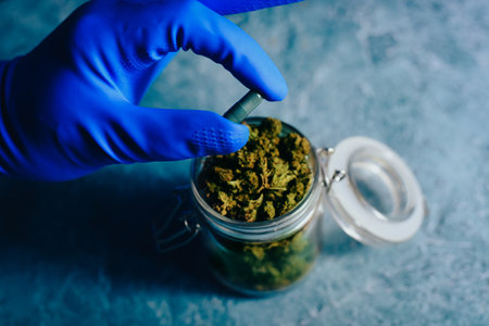 Cones of marijuana in the hands of a doctor. Marijuana pills cbd and thc. Drugs in treatment, medicineの写真素材