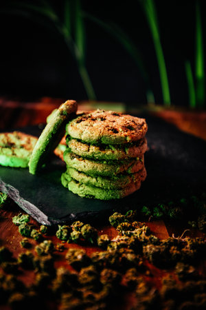 Marijuana cookies, drugs in food, thc and cbd brownies. Sweet on the background of marijuana green neonの写真素材