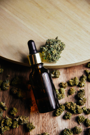 Marijuana cbd and tgc. Marijuana buds are on the table. Jar for oil, cosmetics with pipette.の写真素材