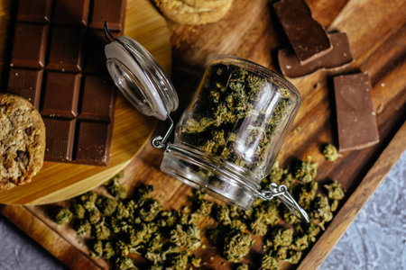Chocolate and cookies with marijuana on the background of a wooden table and marijuana cones. CBD and THC, sativa and indica. marijuana grass in foodの写真素材