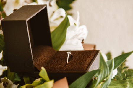 Wedding ring in a box close-up, gold ring with a diamond in flowers. Wedding, February 14, Valentine's Day, proposal for the bride, jewelry.の写真素材