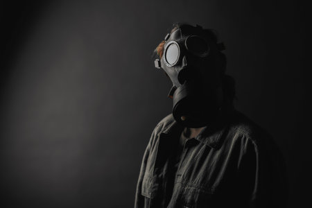 Photo of a military in a gas mask, apocalypse, nuclear weapons, atomic explosion of a station, chemical and nuclear weapons protection. Girl in a mask on a background, war noise, selective focus, moveの写真素材