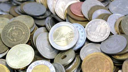 Macro of a group of coins from around the world with the euro in the foreground