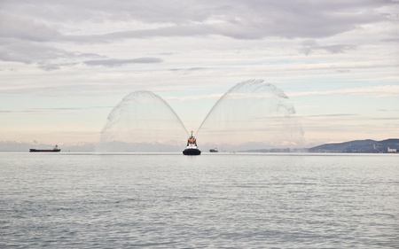 Tug boat in action during a public event in the Gulf of Trieste, Italyのeditorial素材