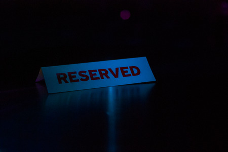 Reserve Signboard On Grunge Wood Table Night clubの写真素材