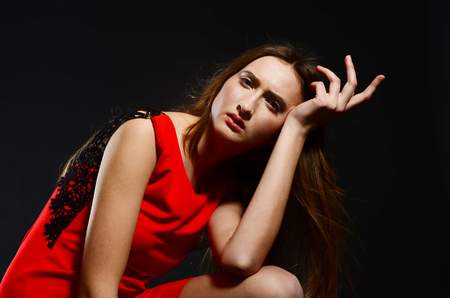 beautiful young caucasian woman portrait on black background.の写真素材