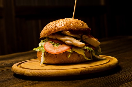 Bacon burger with beef patty on wooden tableの写真素材