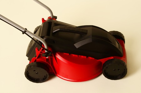 Lawnmower Isolated on White Background. Gas Lawn Mower. Red Grass-Cutter. Garden Equipment. Garden Power Tools.の写真素材