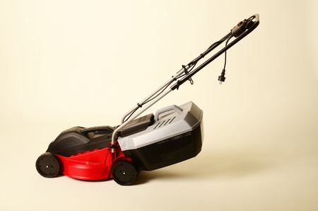 Lawnmower Isolated on White Background. Gas Lawn Mower. Red Grass-Cutter. Garden Equipment. Garden Power Tools.の写真素材