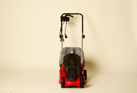 Lawnmower Isolated on White Background. Gas Lawn Mower. Red Grass-Cutter. Garden Equipment. Garden Power Tools.の写真素材