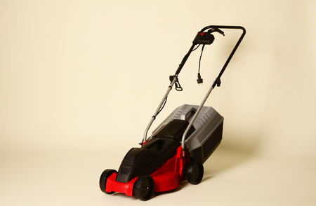 Lawnmower Isolated on White Background. Gas Lawn Mower. Red Grass-Cutter. Garden Equipment. Garden Power Tools.の写真素材