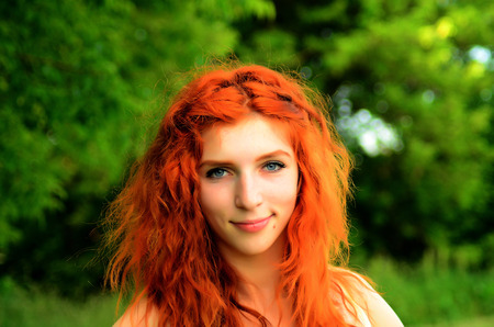 A young beautiful ore girl of the Caucasian appearance is having fun with pineapple. Place for text.Vegan, vegetarianism, healthy lifestyle, positive concept.の写真素材