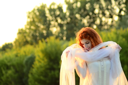 A young beautiful ore girl of the Caucasian appearance is having fun with pineapple. Place for text.Vegan, vegetarianism, healthy lifestyle, positive concept.の写真素材