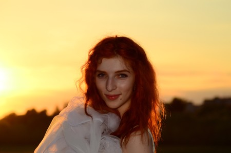 A young beautiful ore girl of the Caucasian appearance is having fun with pineapple. Place for text.Vegan, vegetarianism, healthy lifestyle, positive concept.の写真素材