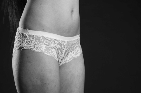 lovely slim model posing against dark background.の写真素材
