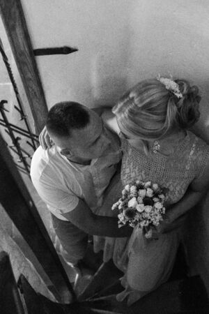 Happy bride and groom walking on gren golf course outdoors, copy space. Wedding couple in love, newlyweds. Wedding concept, bridal bouquet in bride's hands Lutsk Ukraine 04.08.2018.のeditorial素材