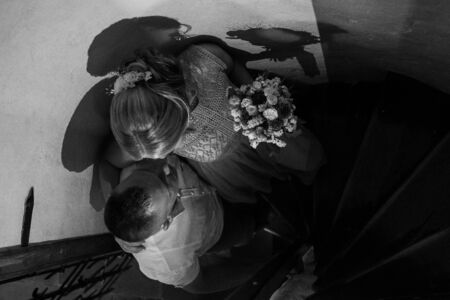 Happy bride and groom walking on gren golf course outdoors, copy space. Wedding couple in love, newlyweds. Wedding concept, bridal bouquet in bride's hands Lutsk Ukraine 04.08.2018.のeditorial素材