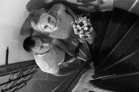 Happy bride and groom walking on gren golf course outdoors, copy space. Wedding couple in love, newlyweds. Wedding concept, bridal bouquet in bride's hands Lutsk Ukraine 04.08.2018.のeditorial素材