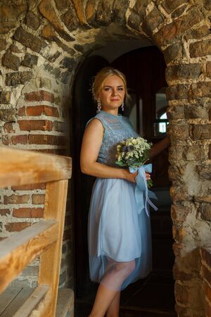 Happy bride and groom walking on gren golf course outdoors, copy space. Wedding couple in love, newlyweds. Wedding concept, bridal bouquet in bride's hands Lutsk Ukraine 04.08.2018.のeditorial素材