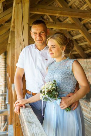 Happy bride and groom walking on gren golf course outdoors, copy space. Wedding couple in love, newlyweds. Wedding concept, bridal bouquet in bride's hands Lutsk Ukraine 04.08.2018.のeditorial素材