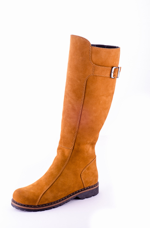 Beige Woman Long Boot Shoe Isolated on White Background. Fashionable boots for women may exhibit all the variations seen in other fashion footwear. Tapered or spike heels, platform soles, pointed toes.の写真素材