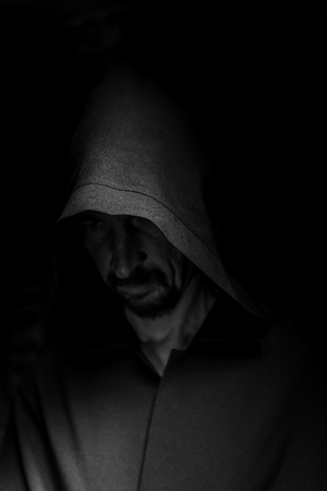 Portrait of a courageous warrior wanderer in a black cloak. Historical fantasy. Halloweenの写真素材