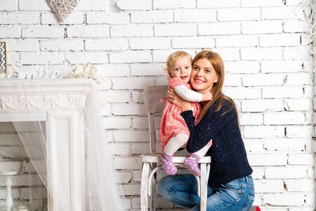 Family at Christmas with the boy. New Year photo session in the studio. Dad and his mom on holidays communicate with his son in the living room. Lutsk, Ukraine 28.12.18のeditorial素材