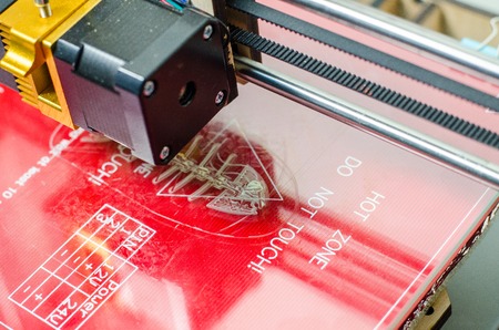 Modern 3D printer printing figure close-up macro.