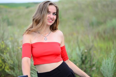 Beautiful girl riding bike at fields at sunset. Ukraine Lutsk 03-08-2017のeditorial素材