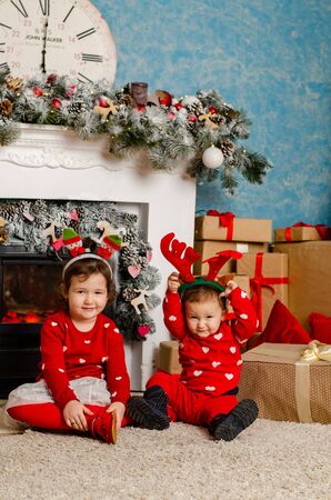 Family at Christmas with the boy. New Year photo session in the studio. Dad and his mom on holidays communicate with his son in the living room. Lutsk, Ukraine 28.12.18のeditorial素材