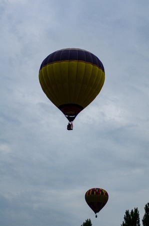 hot air balloon is flying at sunrise.の写真素材
